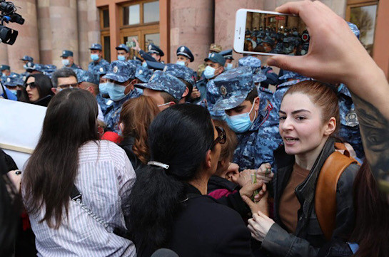 Police officers apprehend women protesters outside Armenia’s government building